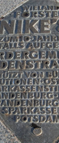 Tafel für Wieland Försters NIKE; Bronze; 75 x 75 cm; 2002; Glienicker Brücke; Potsdam